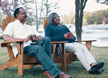 Older couple relaxing outside on scenic water front