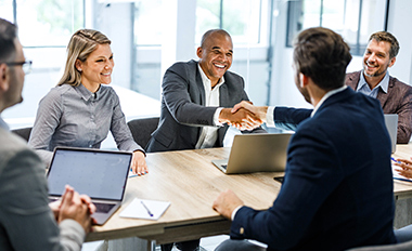 two men shaking hands in business meeting