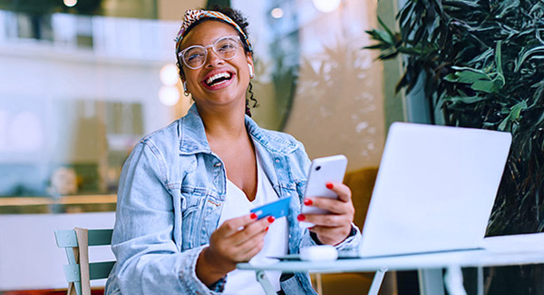 African-American woman using Debit Card with Mobile Device