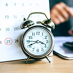 Calendar and alarm clock on desk